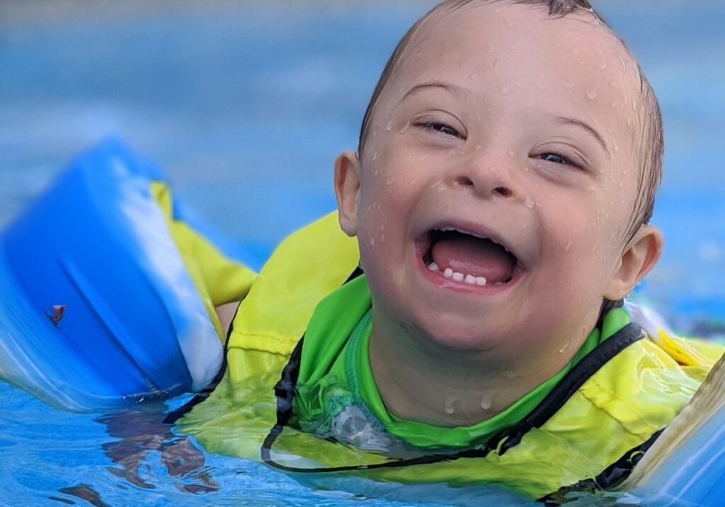 Child with Down syndrome swimming